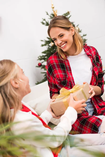 Mother and daughter with christmas present — Stock Photo