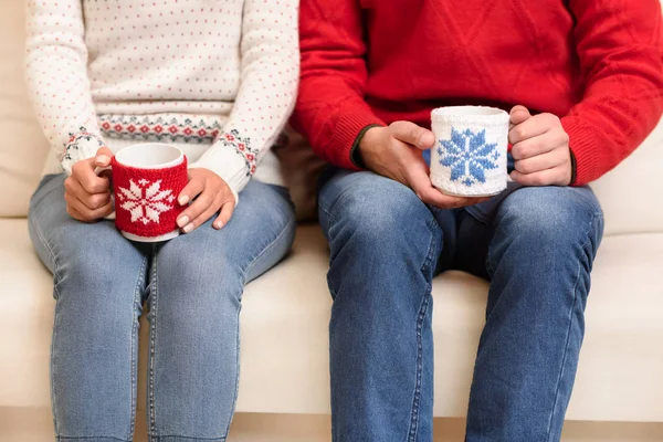 Couple with cups at christmastime — Stock Photo