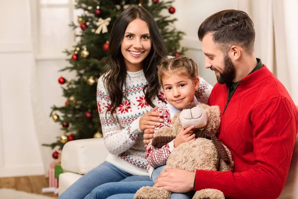 Família feliz com ursinho de pelúcia no Natal — Fotografia de Stock