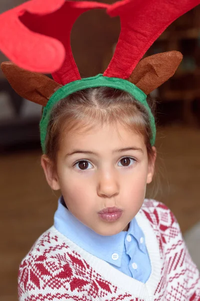 Child in antlers — Stock Photo