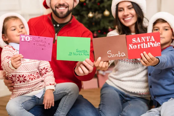 Family with letters for santa — Stock Photo