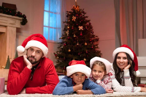 Bonne famille dans les chapeaux de Père Noël — Photo de stock