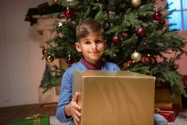 Child holding christmas present — Stock Photo