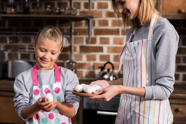 Family with raw chicken eggs — Stock Photo