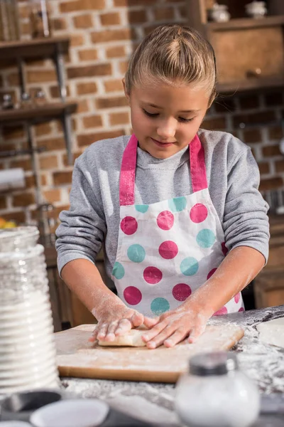 Kid rolling dough — Stock Photo