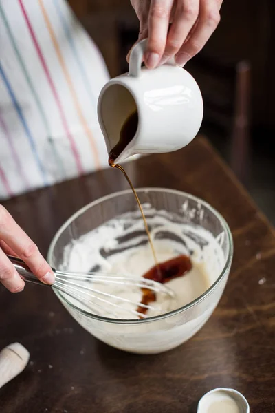 Woman adding honey into bowl — Stock Photo