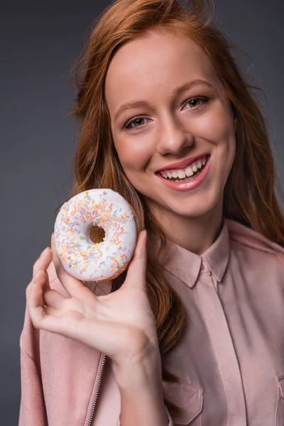 Redhead girl with donut — Stock Photo