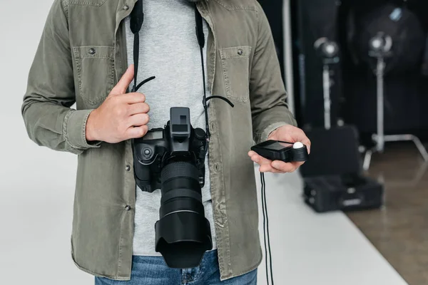 Photographer with camera and light meter — Stock Photo