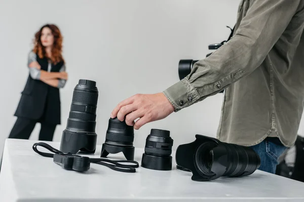 Photographer with camera and lenses — Stock Photo