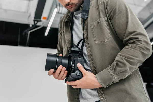 Photographer with digital camera and lens — Stock Photo