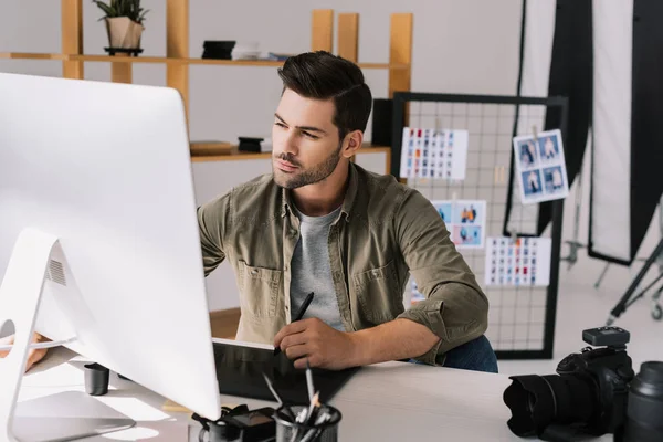 Photographer working with graphics tablet — Stock Photo