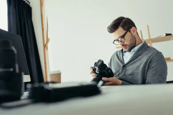 Photographer working in modern office — Stock Photo