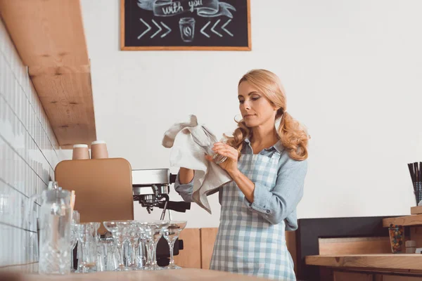 Cafe worker cleaning utensil — Stock Photo