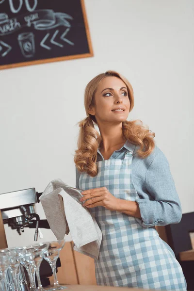 Cafe worker cleaning utensil — Stock Photo