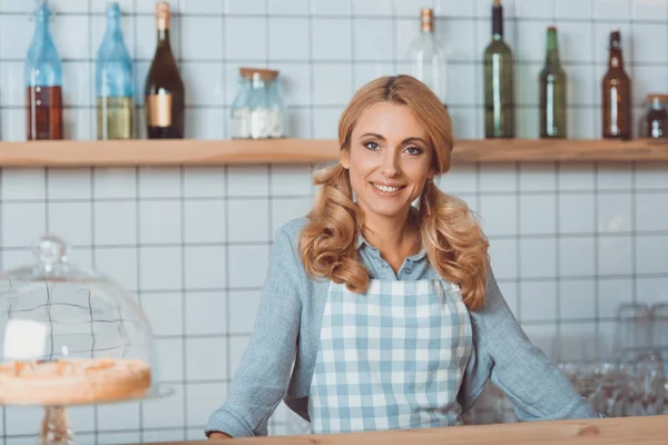 Beautiful cafe owner in apron — Stock Photo