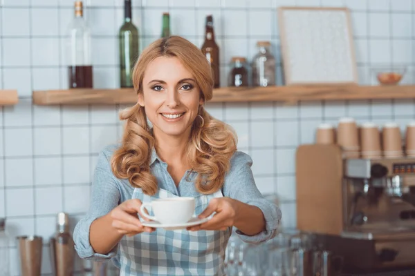 Waitress giving mug with coffee — Stock Photo