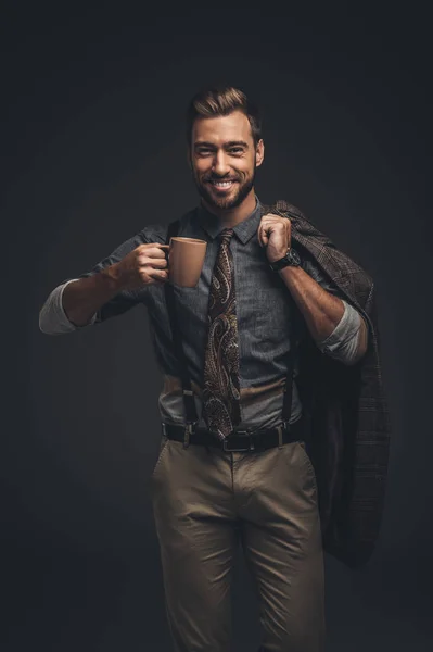 Hombre guapo sosteniendo una taza de café - foto de stock