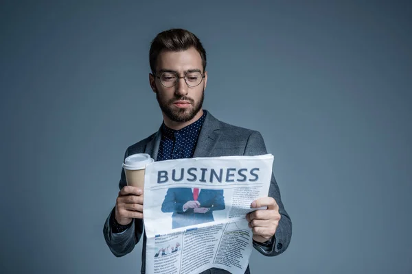 Businessman reading newspaper — Stock Photo