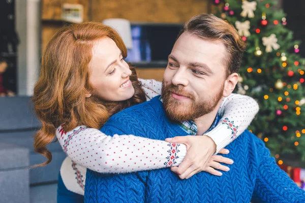 Couple in warm sweaters embracing — Stock Photo