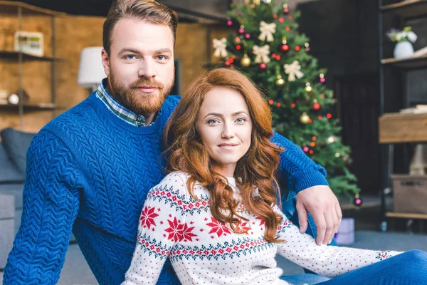 Couple assis dans la chambre décorée de Noël — Photo de stock