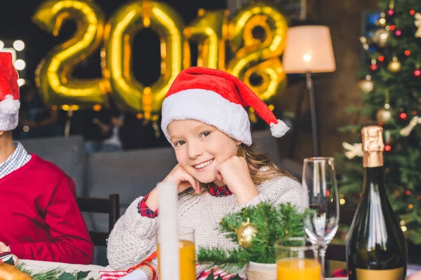 Дівчина сидить за різдвяним столом — Stock Photo