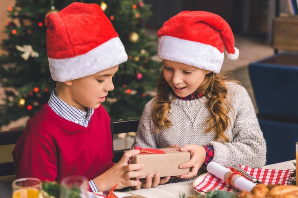 Little boy giving present to sister — Stock Photo