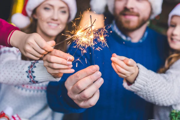 Family with sparkle sticks — Stock Photo