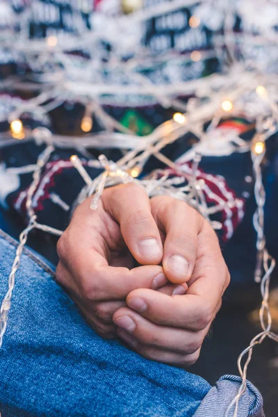 Man tied up with christmas garland — Stock Photo
