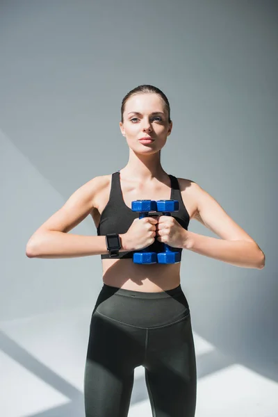 Athletic girl with dumbbells — Stock Photo