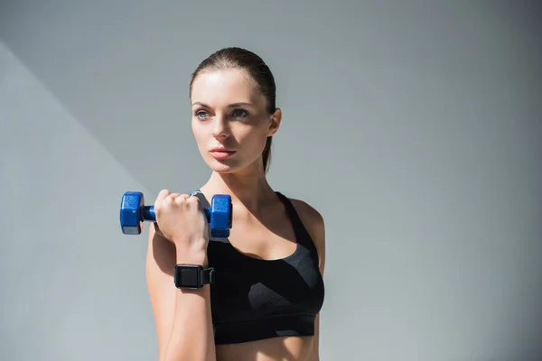 Athletic girl with dumbbell — Stock Photo