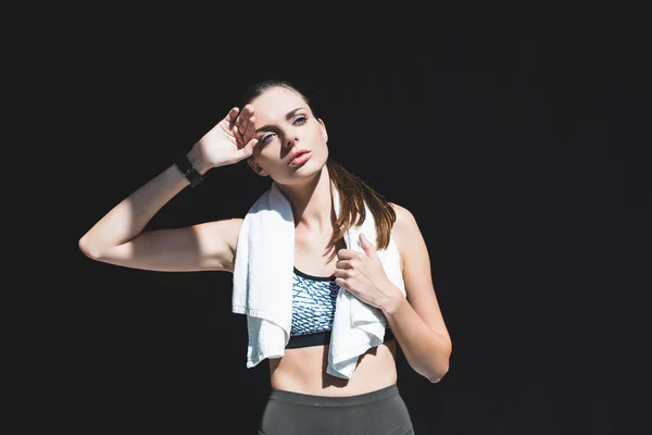 Tired sportswoman with towel — Stock Photo