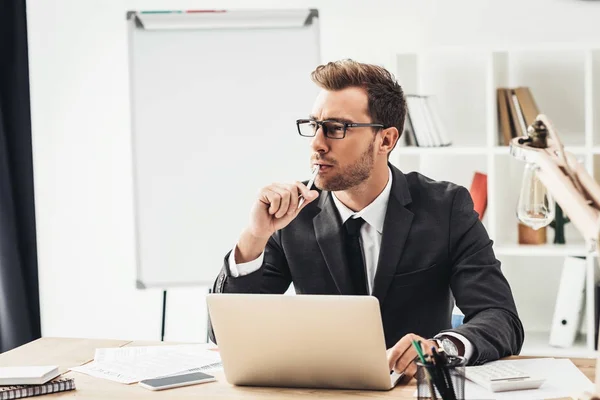Thoughtful businessman at workplace — Stock Photo