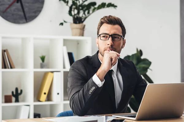 Thoughtful businessman at workplace — Stock Photo