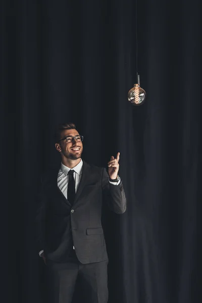 Handsome businessman with lightbulb — Stock Photo
