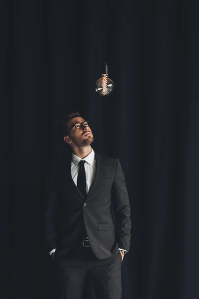 Handsome businessman with lightbulb — Stock Photo