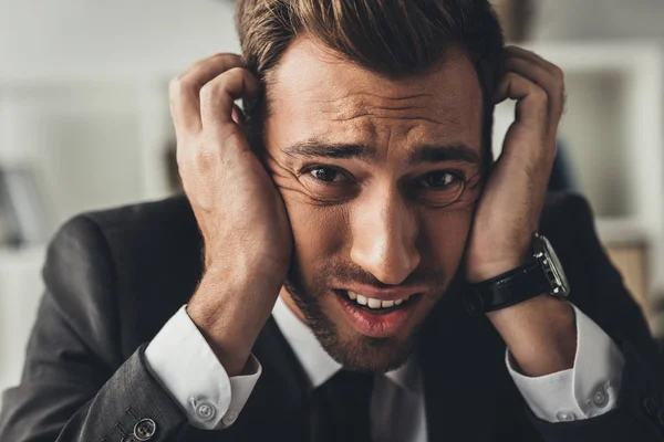 Depressed businessman holding head — Stock Photo