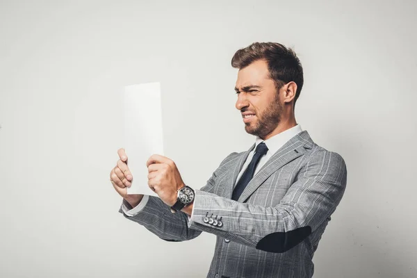 Businessman looking at paper — Stock Photo