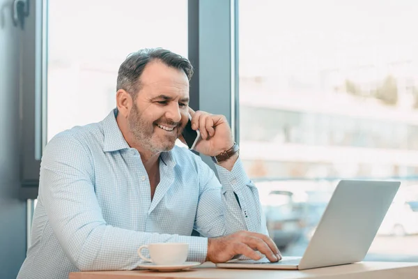 Businessman talking by phone — Stock Photo