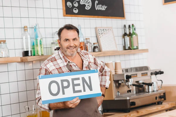 Bartender with open signboard — Stock Photo