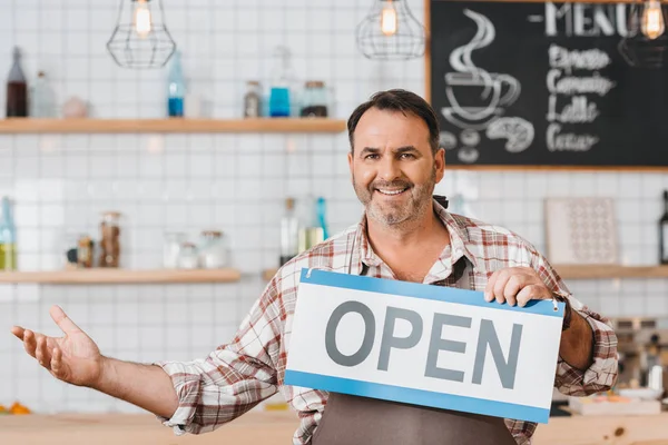 Bartender with open signboard — Stock Photo