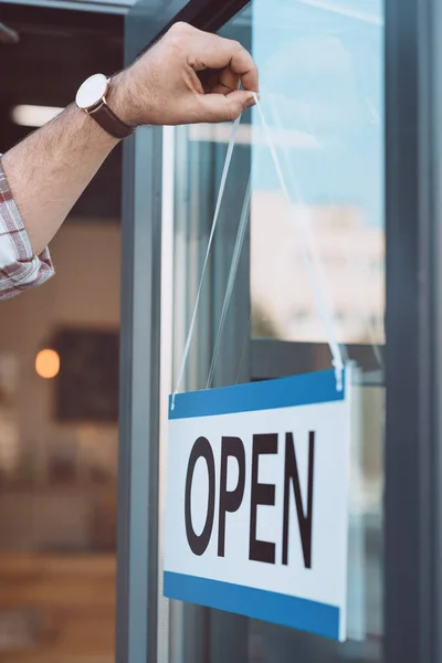 Man hanging open signboard — Stock Photo