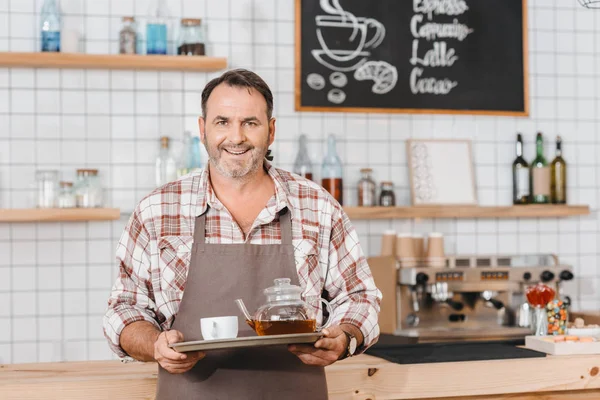 Bartender with tea on tray — Stock Photo