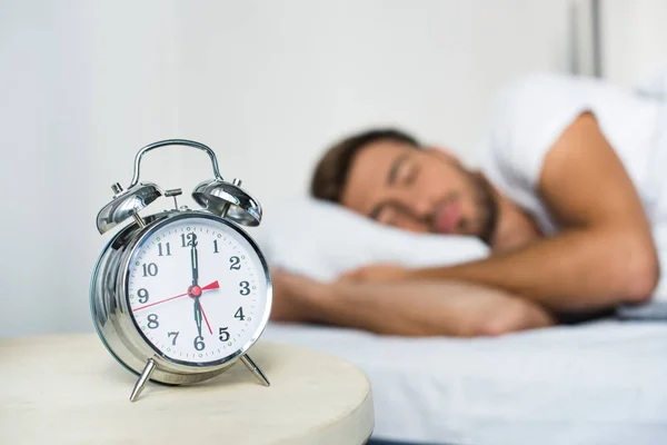 Alarm clock on bedside table — Stock Photo