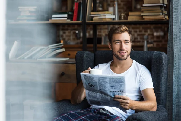 Uomo che legge il giornale a casa — Foto stock