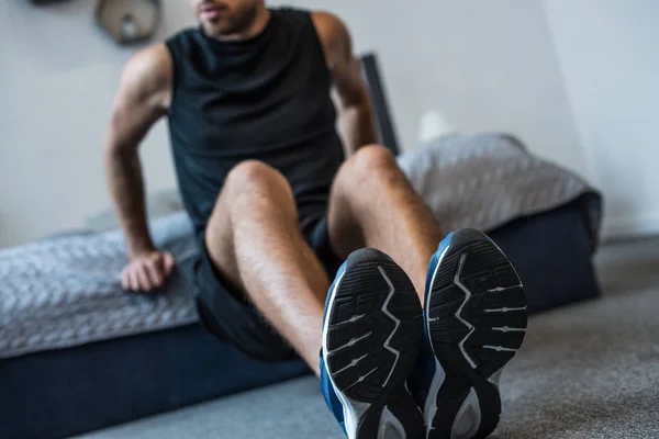 Man doing exercises in bedroom — Stock Photo