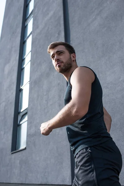 Young sportsman jogging outside — Stock Photo