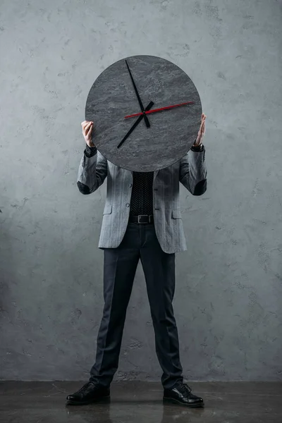 Businessman holding clock — Stock Photo