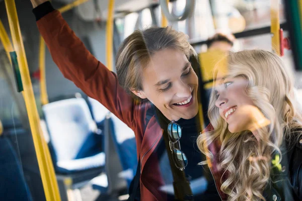 Happy young couple in bus — Stock Photo
