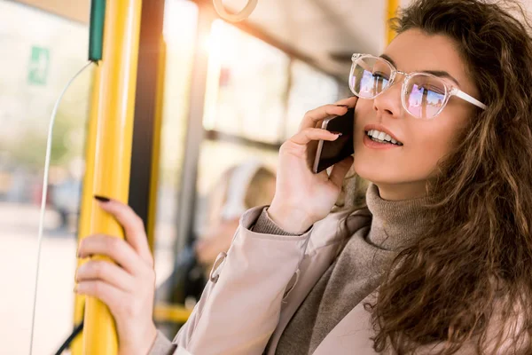 Girl using smartphone in bus — Stock Photo