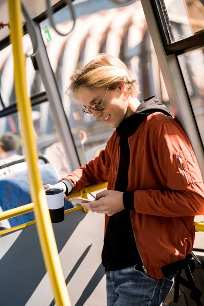 Man using smartphone in bus — Stock Photo